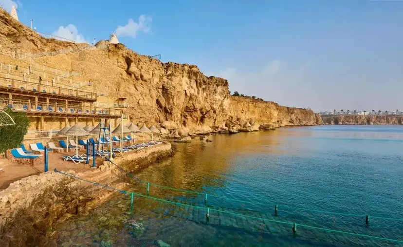 Sun-lit cliffs and turquoise water on the Red Sea coast at Sharm el-Sheikh, Egypt